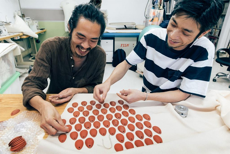 Chan Kiu-hong in discussion with Ken Hung on how to use thousands of Yixing clay scales, a kinetic installation and a specially made fabric to create a crouching beast.